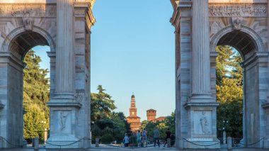 Arco della Pace in Piazza Sempione (Arch of Peace in Simplon Square) timelapse at sunset. Shadow moving on it. Sforza Castle on background. It is a neoclassical triumph arch, 25 m high and 24 m wide, built between 1807 and 1838. Blue cloudy sky at su clipart