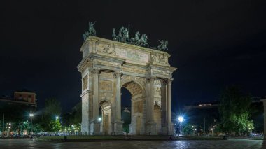 Arco della Pace Piazza Sempione (kemer barış Simplon Meydanı'nda) timelapse hyperlapse geceleri aydınlatılan içinde. 1807 ve 1838 arasında inşa edilmiş bir neoklasik triumph arch, 25 m yüksek ve geniş, 24 m olduğunu. Arka plan üzerinde Rating