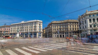 Cordusio Square and Dante street with surrounding palaces, houses and buildings timelapse hyperlapse in Italian capital of fashion and luxury. Trams passing by. Monument to writer and poet Giuseppe Parini. Blue sky at summer day clipart