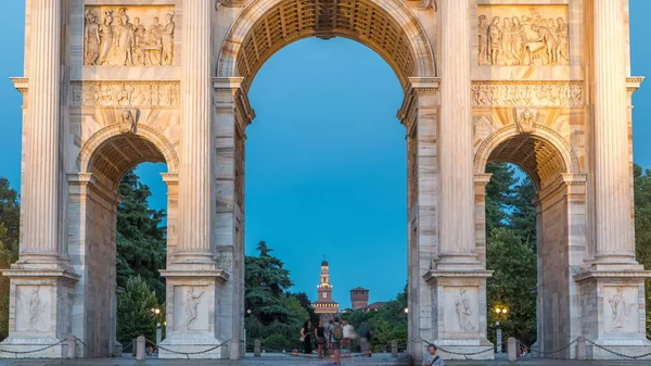 Arco della Pace in Piazza Sempione (Arch of Peace in Simplon Square) day to night transition timelapse. Evening illumination. Sforza Castle on background. It is a neoclassical triumph arch, 25 m high and 24 m wide, built between 1807 and 1838.