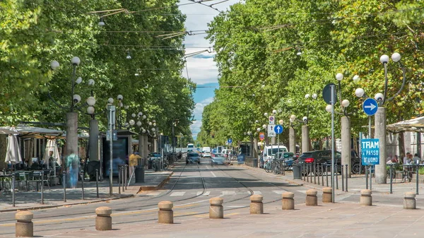 Corso Sempione timelapse, one of the main radial boulevards of Milan, directed north-west from Arco della Pace, here viewed from Piazza Sempione. Traffic cars and tram. Summer day