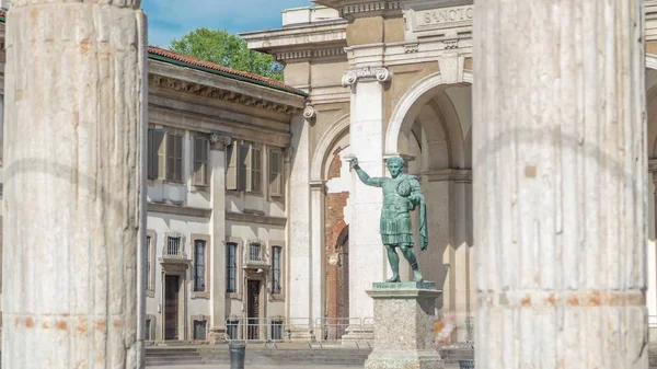 Monument to Roman emperor Constantine I timelapse framed by columns in Milan, in front of San Lorenzo Maggiore basilica. This bronze statue is a modern copy of a Roman statue in Rome.