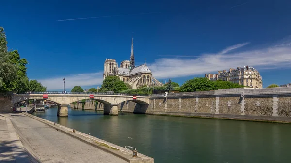 Seine and Notre Dame de Paris timelapse hyperlapse is the one of the most famous symbols of Paris. Bridge of the Archbishopric. View from embankment at sunny summer day