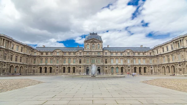 inner yard of louvre with fountain timelapse hyperlapse. Cloudy sky at summer day. Paris, France