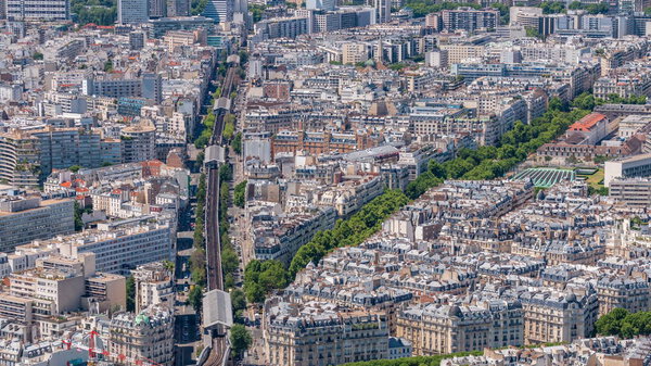 Top view of Paris skyline from above timelapse. Main landmarks of european megapolis with Boulevard de Grenelle and metro line. Bird-eye view from observation deck of Montparnasse tower. Paris, France