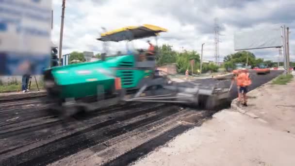 Um acabador de pavimentação, acabamento de asfalto ou máquina de pavimentação colocando uma camada de asfalto durante um projeto de reconstrução timelapse — Vídeo de Stock