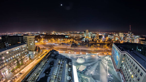 Kharkiv city from above at night winter timelapse. Aerial view of the city center and freedom square. Ukraine.