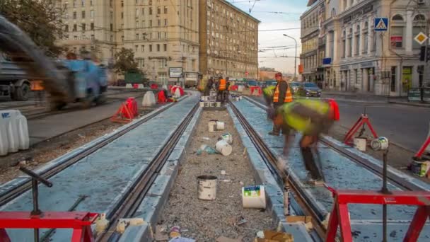 Tramvajová kolejnice ve fázi jejich instalace a integrace do betonové desky na silnici timelapse. — Stock video