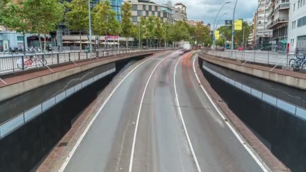 Traffic passes through an underpass on the Gran Via de les Corts Catalanes as it heads towards the city centre timelapse. Barcelona, Spain — Stock Video