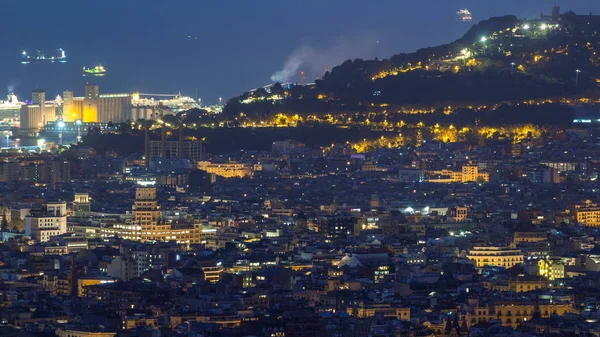 Panorama of Barcelona night timelapse, Spain, viewed from the Bunkers of Carmel on a cloudy morning before sunrise. Aerial top view from hill with port. City lights turning off