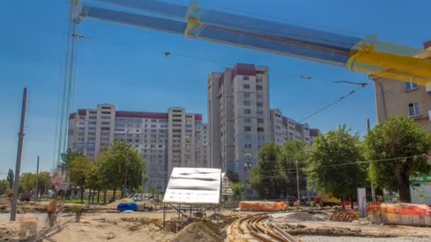 Orange construction telescopic mobile crane moving tram rails timelapse. — Stock Video