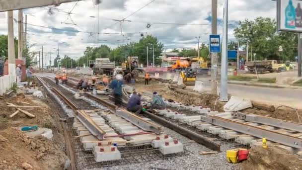 Repair works on the street timelapse. Laying of new tram rails on a city street — Stock Video