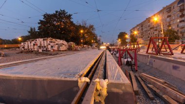 Tramvay rayları onların yükleme ve beton levha entegrasyonu gece timelapse hyperlapse yol gün aşamasında. Titreşim ve noice azaltılması için sıvı reçine ile doldurma. Tramvay yeniden inşası süreci izler