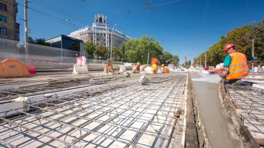 Beton yol yapım birçok işçi ve mikser timelapse hyperlapse ile çalışıyor. Harç metal takviye için dökme. Kaplama ve koruyucu filtre püskürtücü tarafından. Tramvay parça yeniden inşası