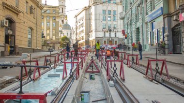 Tram rails at the stage of their installation and integration into concrete plates on the road timelapse. The process of reconstruction of tram tracks clipart