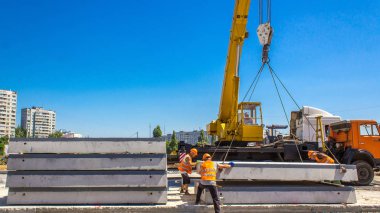 Vinç yol inşaat site timelapse, beton plaka yükleme. Kavganın ve üniforma ile sanayi işçileri. Sokak şehir tramvay yeniden inşası izler