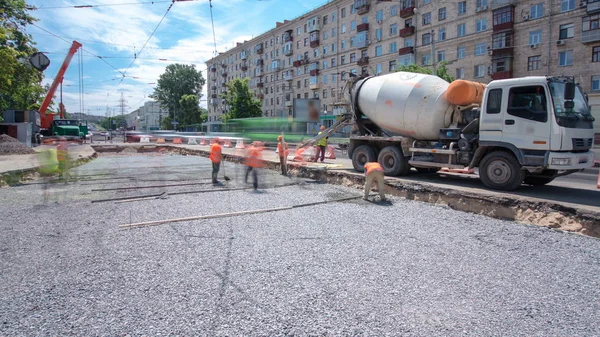 Concrete works for road maintenance construction with many workers and mixer timelapse. Reconstruction of tram tracks