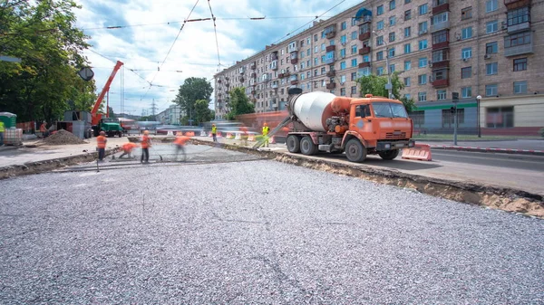 Concrete works for road maintenance construction with many workers and mixer timelapse. Reconstruction of tram tracks