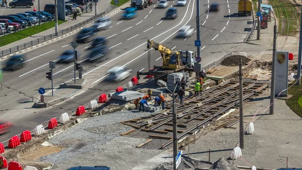 道路建設サイト タイムラプスでクレーン コンクリート板をインストールします Hardhats と制服産業労働者 トラムの復興を街で追跡します — ストック写真