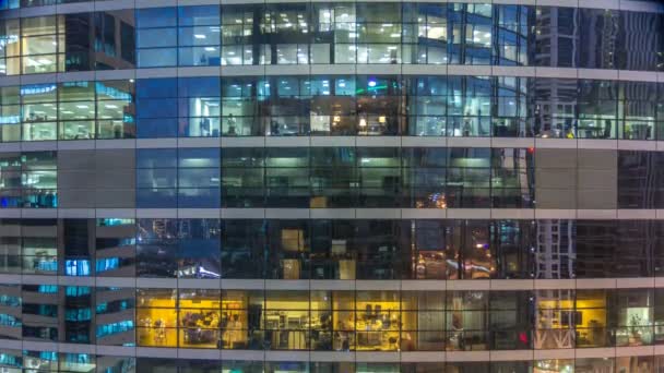Glowing windows in multistory modern glass and metal office building light up at night timelapse. — Stock Video