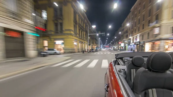 Car moves at fast speed at the night avenue timelapse hyperlapse drivelapse. Blured road with lights reflected from car on high speed. Milan, Italy