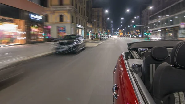 Car moves at fast speed at the night avenue timelapse hyperlapse drivelapse. Blured road with lights reflected from car on high speed. Milan, Italy