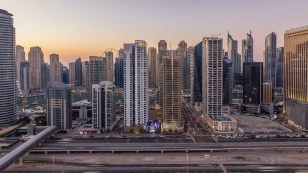 Dubai marina with traffic on sheikh zayed road panorama day to night timelapse lights turn on. — Stock Video