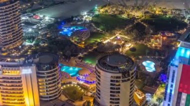 Modern gökdelenler ve Jumeirah Beach Residence Jbr gece timelapse Dubai, BAE kumsalda havadan görünümü