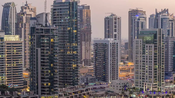 Geçen tekneler ve mesire Restoran gün gece ile lüks Dubai Yat Limanı kanal timelapse geçiş, ışıklandırılmış gökdelenler ile yukarıdan görünüm güneş battıktan sonra Top. Dubai, Birleşik Arap Emirlikleri