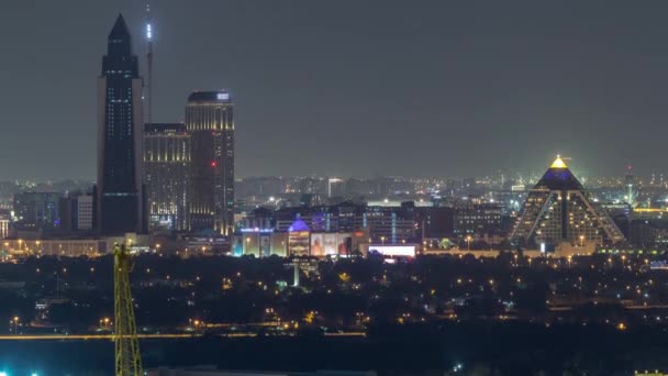 Dubai skyline over the Healthcare City and pyramid illuminated at night timelapse in Dubai, UAE — Stock Video
