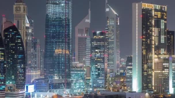 Aerial view on downtown and financial district in Dubai night timelapse, United Arab Emirates with skyscrapers and highways. — Stock Video