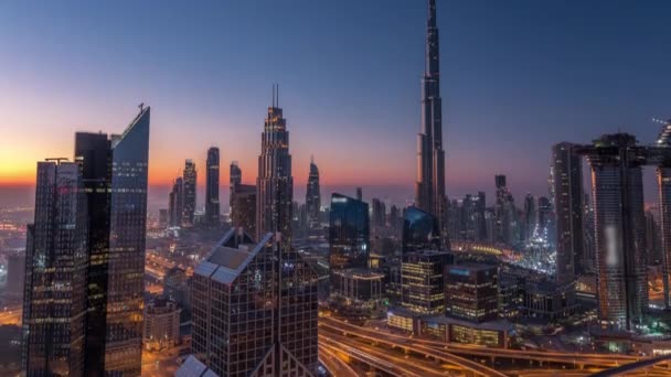 Dubai downtown skyline with tallest skyscrapers and busiest traffic on highway intersection night to day timelapse — Stock Video