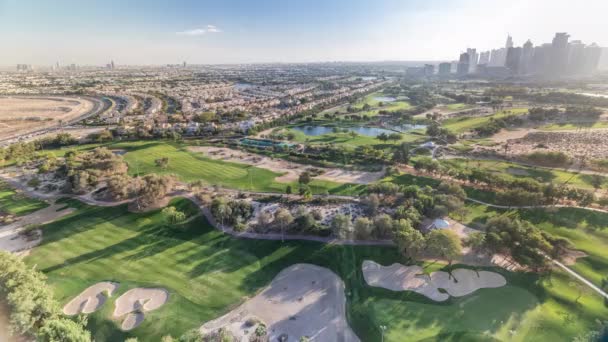 Campo de golfe e lago Jumeirah torres arranha-céus antes do pôr-do-sol timelapse,, Dubai, Emirados Árabes Unidos — Vídeo de Stock