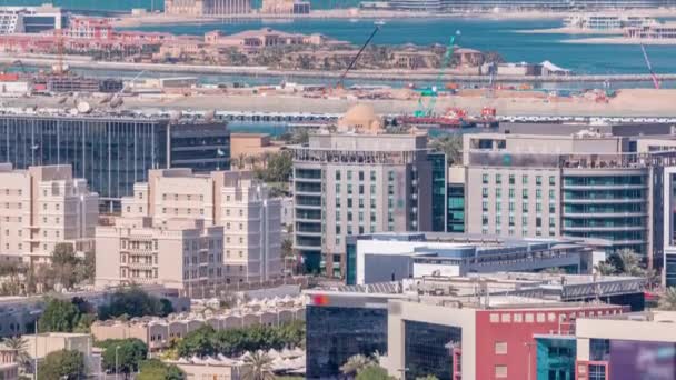 Dubai media city buildings and palm jumeirah on background timelapse, Dubai, United Arab Emirates — Stock Video