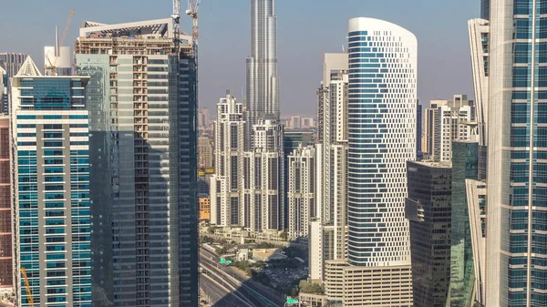 Aerial view of towers in Business Bay with traffic on the road timelapse. — Stock Photo, Image