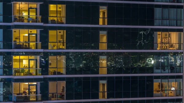 Glowing apartment windows at night in glass skyscraper timelapse — Stock Photo, Image