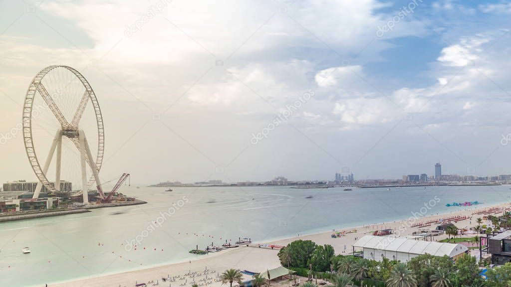 Aerial view of beach and tourists walking and sunbathing on holiday in JBR timelapse in Dubai, UAE