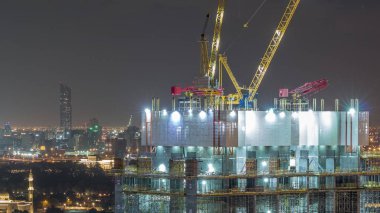 Dubai şehir merkezinde vinçler ve işçiler gece timelapse, Bae ile inşaat faaliyeti.