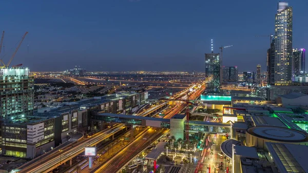 Vista aérea de la carretera del centro financiero día a noche timelapse con edificio en construcción —  Fotos de Stock