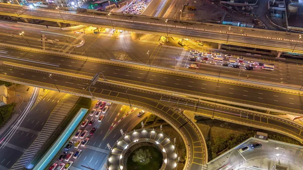 Aerial view of highway interchange in Dubai downtown night timelapse. — Stock Photo, Image