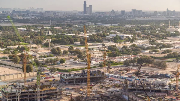 Construction activity in Dubai downtown with cranes and workers timelapse, UAE. — Stock Photo, Image