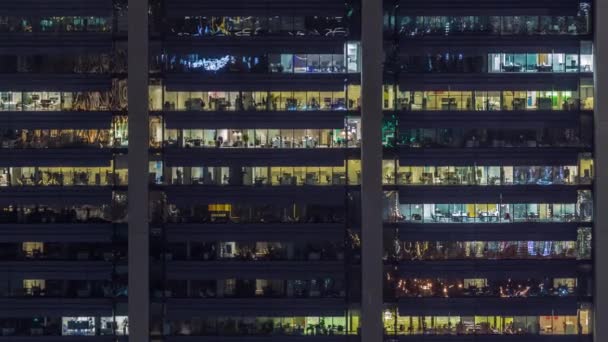 Офисные окна на фасаде современного небоскреба, показывающие деловую активность — стоковое видео