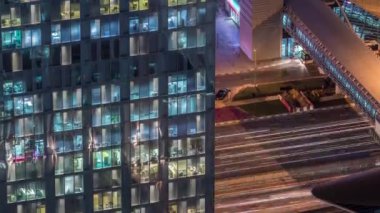 Dış apartman kulesinin gece görüşü. Pencerelerinde yanıp sönen ışıklar olan yüksek gökdelen