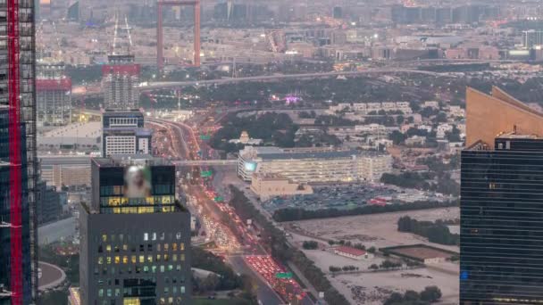 Aerial view to financial and zabeel district day to night timelapse with traffic and under construction building with cranes from downtown — Stock Video