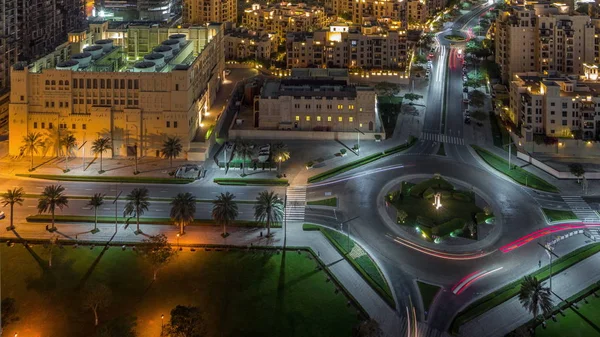 Aerial view of a roundabout circle road in Dubai downtown from above night timelapse. Dubai, United Arab Emirates. — Stock Photo, Image