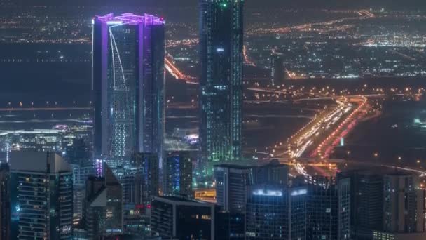 Panoramic aerial view of business bay towers in Dubai night timelapse. — Stock Video