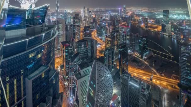 Panoramic aerial view of business bay towers in Dubai night timelapse. — Stock Video