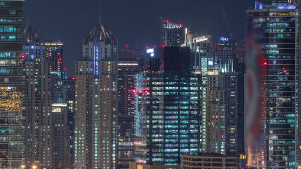 Dubai Marina and JLT aerial night timelapse top view of skyscrapers in Dubai, UAE. Modern towers and traffic on streets