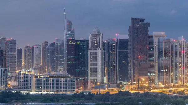 Jumeirah lake towers skyscrapers and golf course night to day timelapse, Dubai, United Arab Emirates — Stock Photo, Image