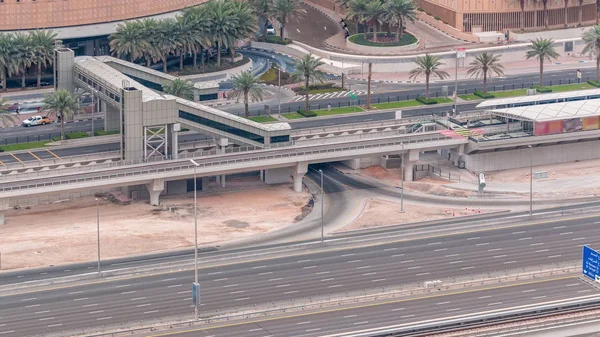 Aerial top view of traffic near mall with footbridge from tram stop timelapse in Dubai Marina in Dubai, UAE. — Stock Photo, Image